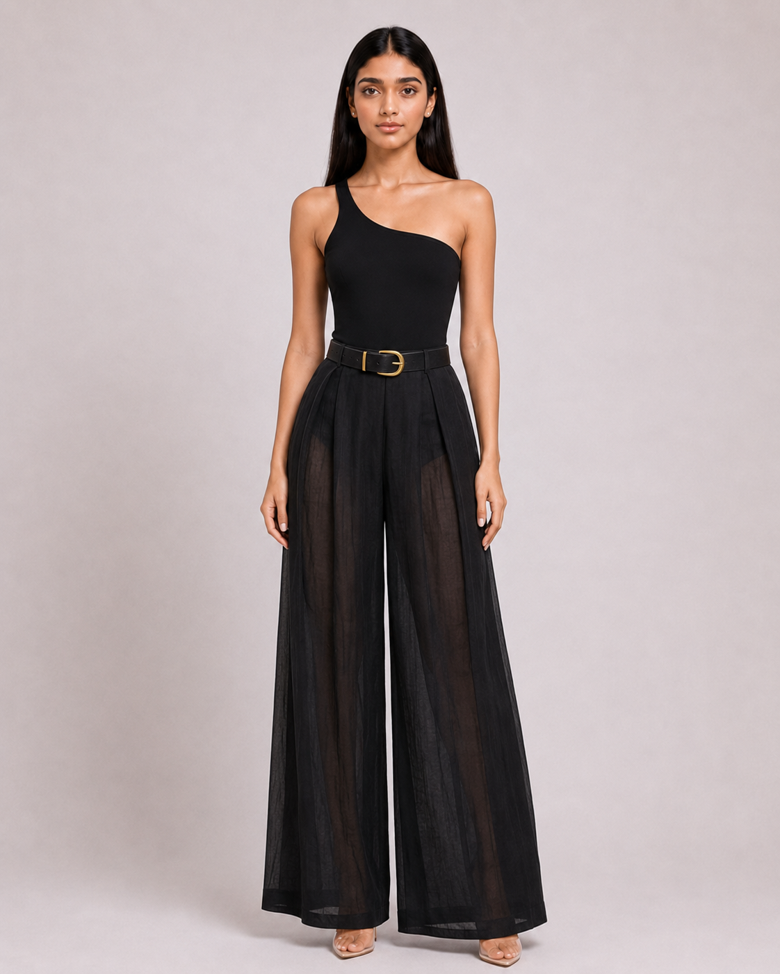 A black one-shoulder jumpsuit with a defined waist and airy sheer panels.