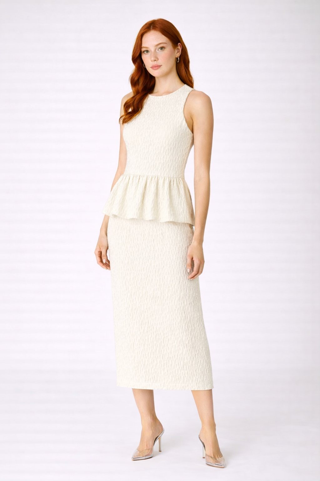 An ivory ruched top and skirt pairing with a close fit and soft draping.